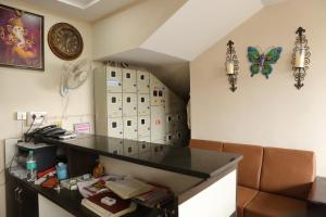an office with a desk and butterfly decorations on the wall at SV Grand in Proddatūr