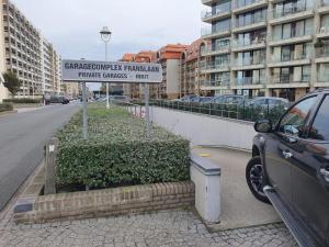 a car parked on the side of a street at CONDO Romain in Nieuwpoort