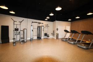 a gym with a bunch of cardio equipment in a room at Castle B6 in Miami Beach