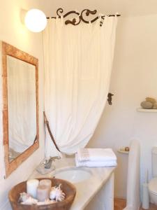 a bathroom with a sink and a mirror at AFOURA HOUSES by K&K in Pyrgos