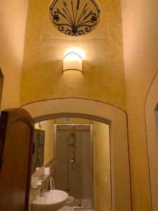 ein Badezimmer mit einem Waschbecken und einer Uhr an der Wand in der Unterkunft Monte Cavallo in Assisi + 65 Fotos