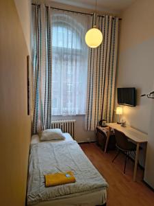 a bedroom with a bed and a desk and a window at U Szermierzy in Wrocław +73 photos