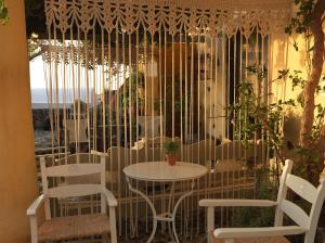 a table and chairs in a room with a window at AFOURA HOUSES by K&K in Pyrgos
