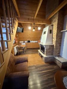 a living room with a stone fireplace in a house at Noclegi u Gubały in Szaflary