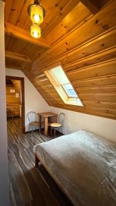 a bedroom with a bed and a wooden ceiling at Noclegi u Gubały in Szaflary