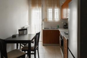 a small kitchen with a table and a table and chairs at Philoxenia Studio Larissa in Larisa