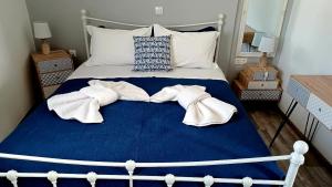a bedroom with a bed with towels on it at Calliope #1 in Skala
