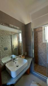 a bathroom with a white sink and a shower at Calliope #1 in Skala +34 photos
