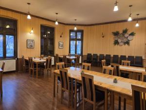 a dining room with wooden tables and chairs at Transylvanian Nest in Cristian +30 photos