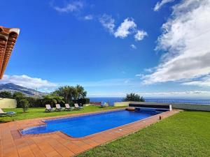a swimming pool with a view of the ocean at Villa Baradaye by Atlantic Holiday in Estreito da Calheta