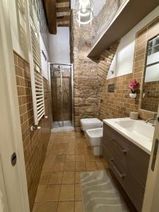 a bathroom with a shower and a toilet and a sink at Vicolo San rufino in Assisi +4 photos