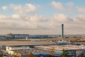 an airport with planes parked on the runway at Radisson Blu CDG Airport Terminal Hotel, Paris in Tremblay-En-France