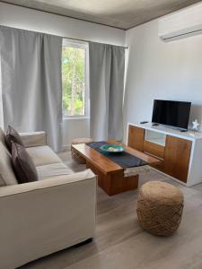 a living room with a couch and a table at Departamento BOSQUE - Unidad 218 in Costa del Este