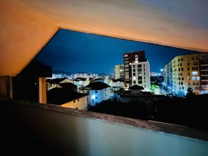 a view of a city skyline at night at Potka Apartments Tirane in Yzberishti