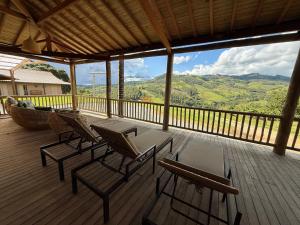 a deck with chairs and a table and a boat at Montinni Hotel in Socorro