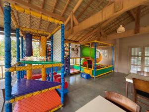 a play room with several different colored play equipment at Montinni Hotel in Socorro
