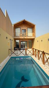 a large swimming pool in front of a house at درة العروس اكواخ الدره in Durat Alarous