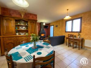 a kitchen with a table and a dining room at Gîte du Cassan in Sénergues