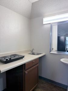 a kitchen with a sink and a counter top at Heritage Inn Cartersville in Cartersville