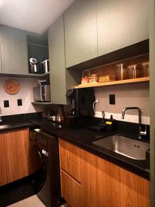 a kitchen with a sink and a dishwasher at Mucugê- Charm Village in Mucugê
