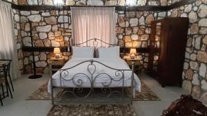 a bedroom with a bed and two tables with lamps at Leo Villas in Florina