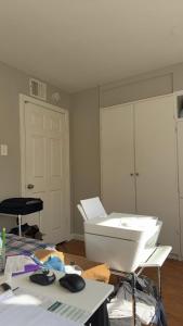 a white room with a toilet and a table at Only 25 dollars-Man's bed in a room in Texas City