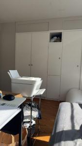 a white room with a sink and a bed at Only 25 dollars-Man's bed in a room in Texas City +2 photos