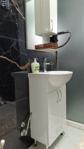 a bathroom with a white sink and a mirror at Leo Villas in Florina +30 photos