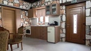 a kitchen with a refrigerator and a stove top oven at Leo Villas in Florina