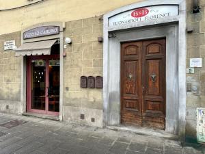 a building with a wooden door on the side of it at Paraiso in Florence +19 photos