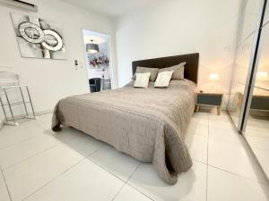 a bedroom with a large bed with two pillows at Cannes Maria in Cannes
