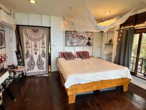 a bedroom with a bed with pillows on it at Seaview Love Nest in Ko Phangan