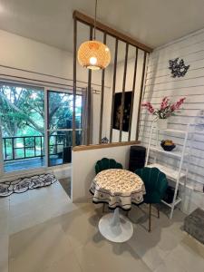 a living room with a table and chairs and a window at Seaview Love Nest in Ko Phangan