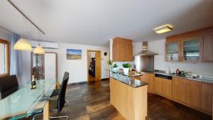 a kitchen with wooden cabinets and a glass counter top at Bijou in Mitten von Naters in Naters