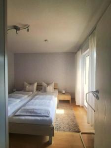 a bedroom with two beds and a window at Ferienwohnung Borken in Bad Salzungen