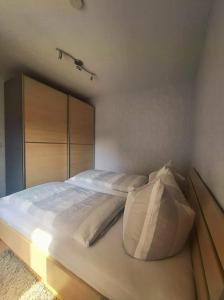 a bedroom with a large bed with white pillows at Ferienwohnung Borken in Bad Salzungen