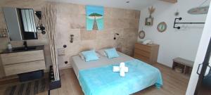 a room with a bed with a cross on it at O'sun avec jacuzzi privatif in Frontignan +23 photos