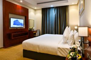 a hotel room with a bed and a flat screen tv at Best Day Hotel and Resorts المحمدية in Jeddah +67 photos
