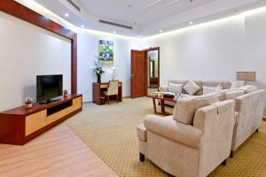 a living room with a couch and a flat screen tv at Best Day Hotel and Resorts المحمدية in Jeddah