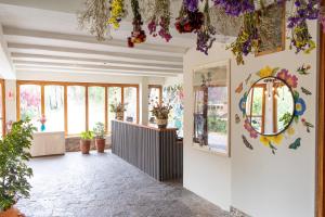 a hallway with a mirror and flowers on the wall at Tariq Sacred Valley in Urubamba