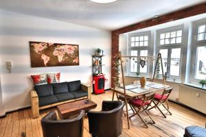 a living room with a couch and a table at Altstadtblick Altenburg in Altenburg