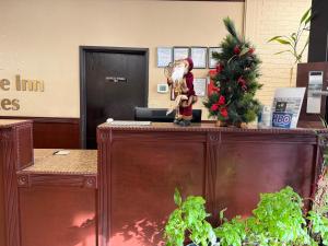 HesstonFairview Inn By OYO Hesston I-135的桌子上摆着一棵圣诞树，旁边还有一个圣诞老人摆件。