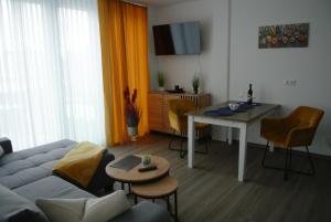 a living room with a couch and a table at Ferienwohnung Meer-Zeit in Lubmin