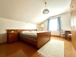 a bedroom with a bed and a window and a rug at Ferienwohnung Feicht`n Schuster in Gosau