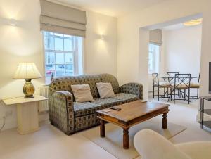 a living room with a couch and a table at 1a Tower Street - Emsworth in Emsworth
