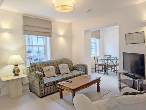 a living room with a couch and a tv at 1a Tower Street - Emsworth in Emsworth