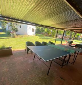a ping pong table with chairs under a tent at " Casa quinta "San Bernardo" Con Pileta y amplio jardín in Posadas
