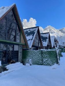 a house with snow on the roofs in the snow at River Bungalov in Rize