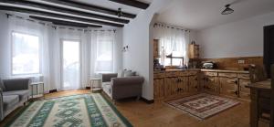 a kitchen with a couch and a chair in a room at The Froggies in Gura Negri