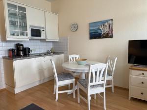 a kitchen and dining room with a table and chairs at Fürstenhof Sassnitz in Sassnitz